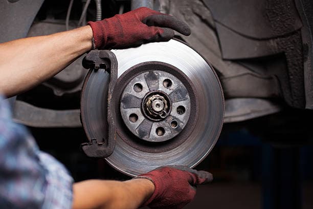 Mobile brake repair service on a vehicle rotor